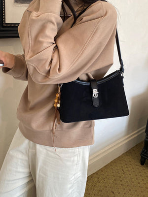handbag in black featuring buckle detail and structured fit