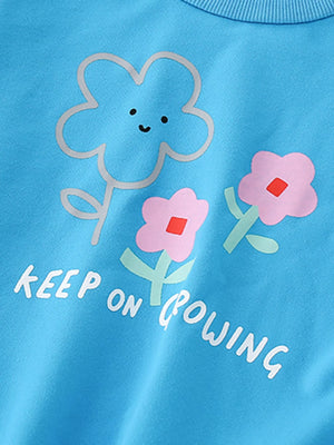 Baby sweatshirt in sky blue with floral print and "KEEP ON GROWING" text.