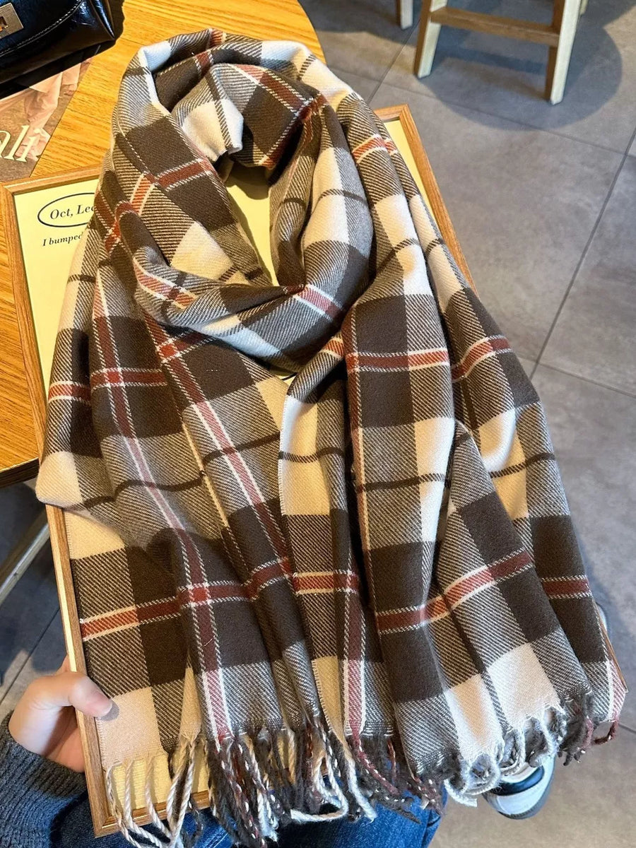 Plaid fringe scarf in taupe with white and red accents, featuring a cozy, heritage-inspired design.
