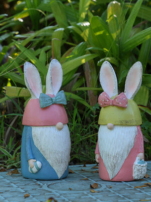 Easter bunny gnomes in pastel blue and blush pink with decorative bows and baskets.