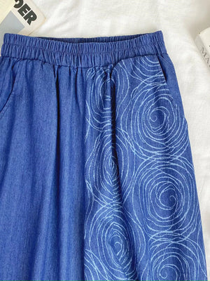 Blue cotton blend jeans with elastic waist and white rose print detail