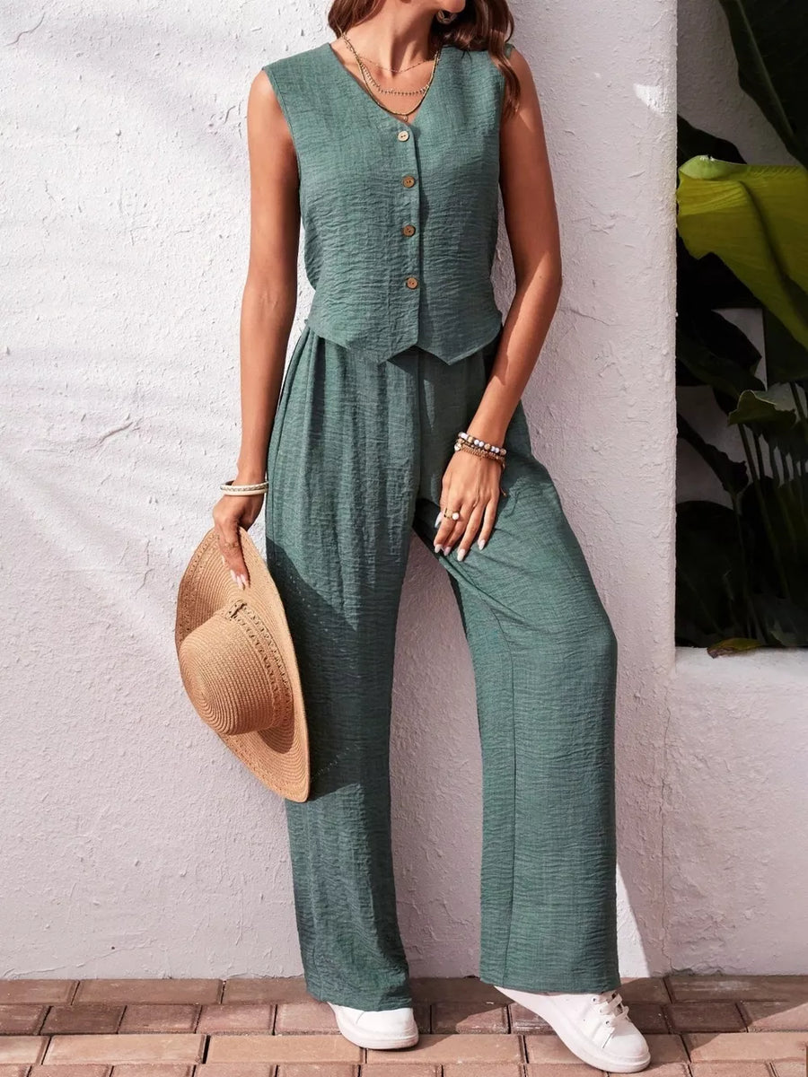 Turquoise buttoned cropped vest and wide-leg pants set with textured fabric.