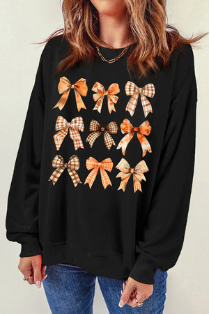 Black crewneck sweatshirt with a grid of autumn-themed bow prints.
