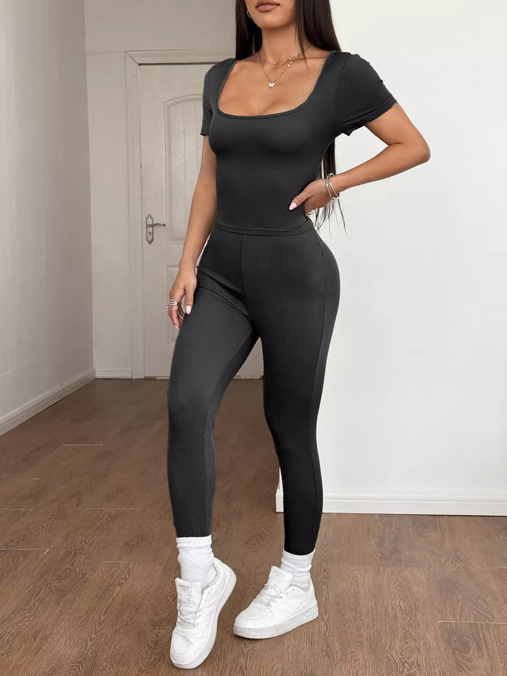 Black ribbed knit short sleeve top and leggings set with a square neckline.
