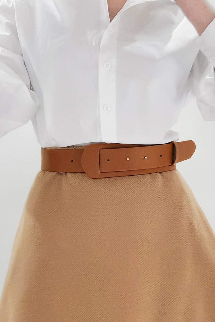 Sculpted leather waist belt in caramel with adjustable buckle and gold-tone studs.