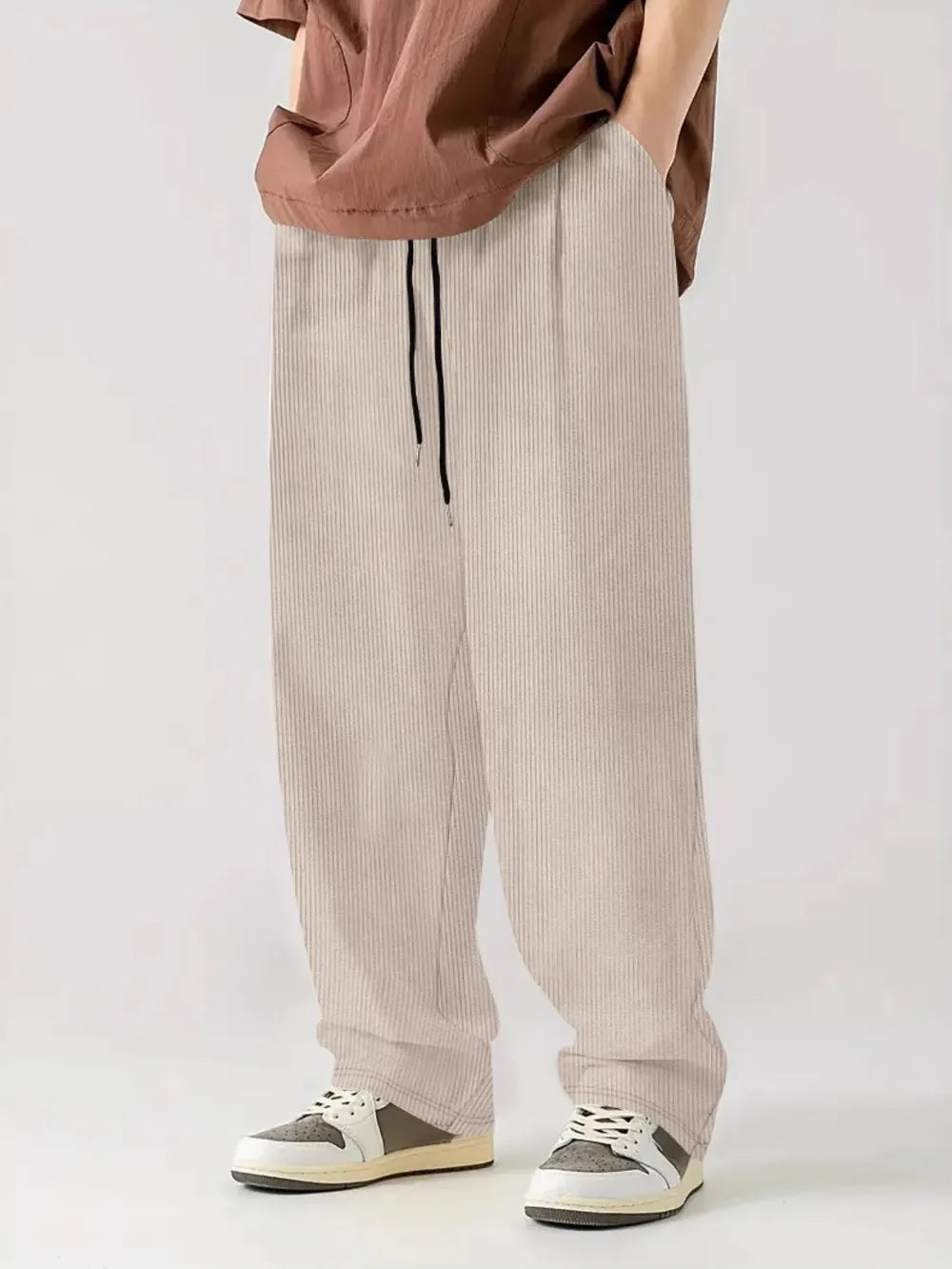 Textured corduroy relaxed fit trousers in white with drawstring waist.
