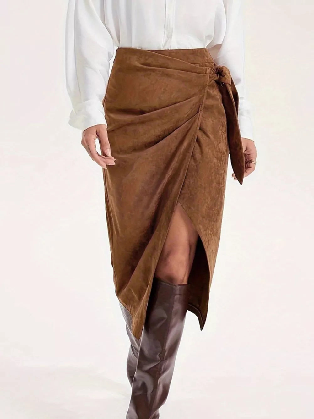 Brown suede midi skirt with tie detail and thigh slit, styled with boots.