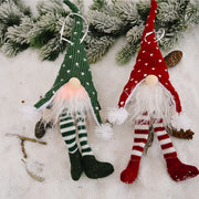 Knitted gnome ornaments in red and green with white hearts and striped legs.