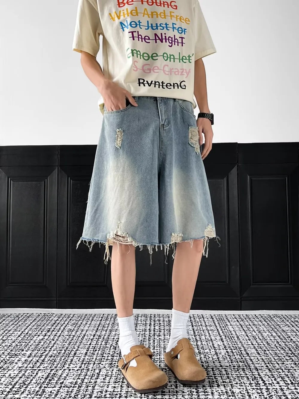 Light-wash distressed denim shorts with raw hem and ripped details.