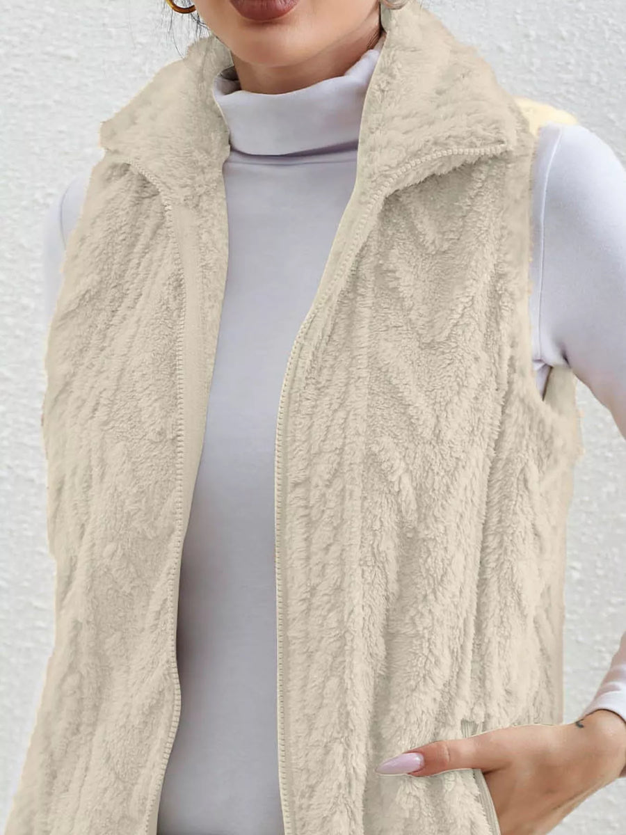 Off-white faux fur zip-up vest with a stand-up collar and textured pattern.