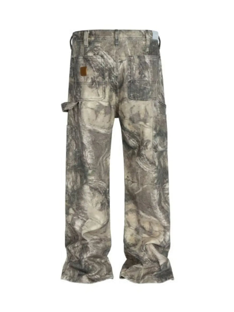 Carpenter jeans in Real Tree camo pattern with raw hem and mocha color.