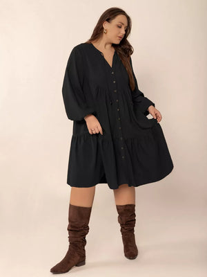 Black plus-size button-front dress with balloon sleeves and tiered skirt.