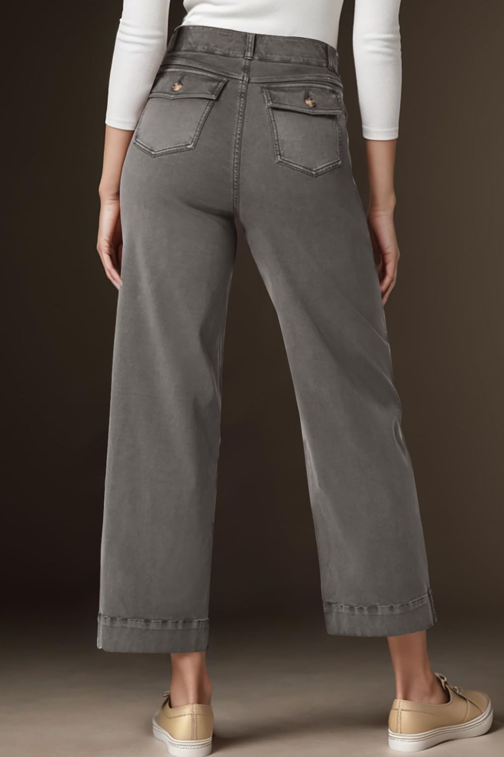 Wide-leg utility denim trousers in light gray with buttoned back pockets and cuffed hems.
