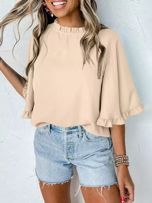 Apricot ruffled mock neck half sleeve shirt with ruffled cuffs.