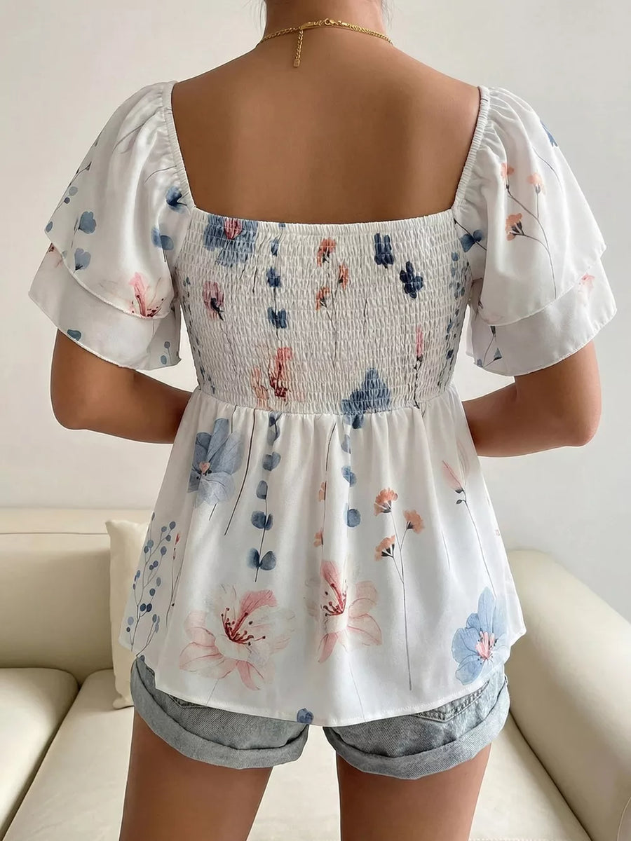 Smocked square neck blouse with flutter sleeves and a floral print.