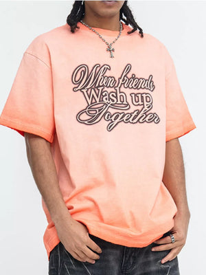 Men's orange vintage wash graphic tee with crew neck and short sleeves.
