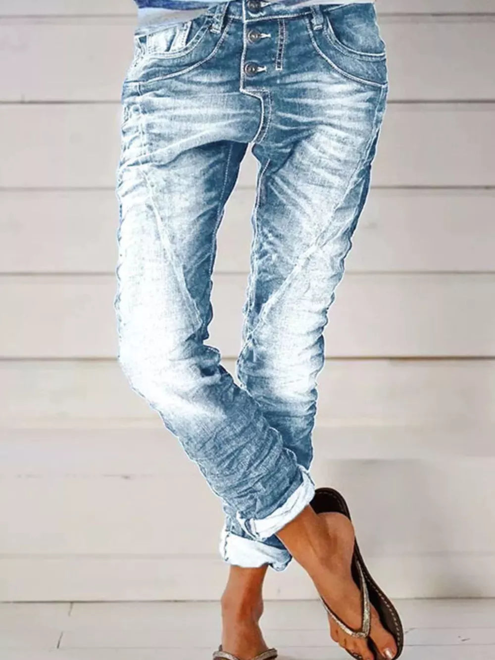 Light blue cuffed button-fly jeans with a relaxed fit and distressed details.