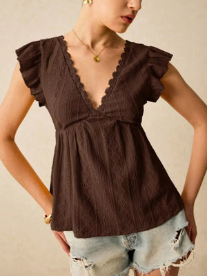 Brown eyelet blouse with lace trim and ruffle sleeves.