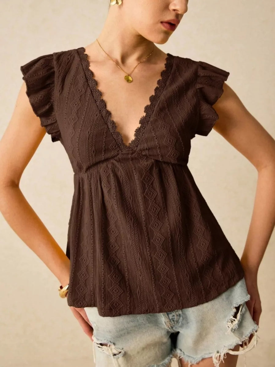 Brown eyelet blouse with lace trim and ruffle sleeves.