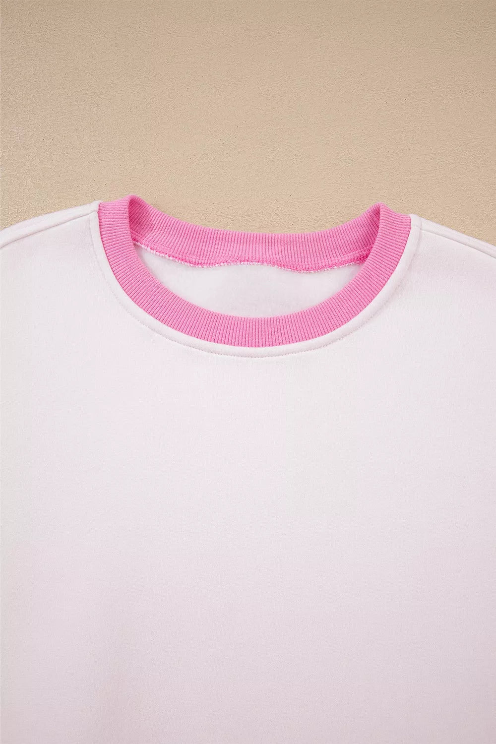 White cotton sweatshirt with pink ribbed crew neck detail