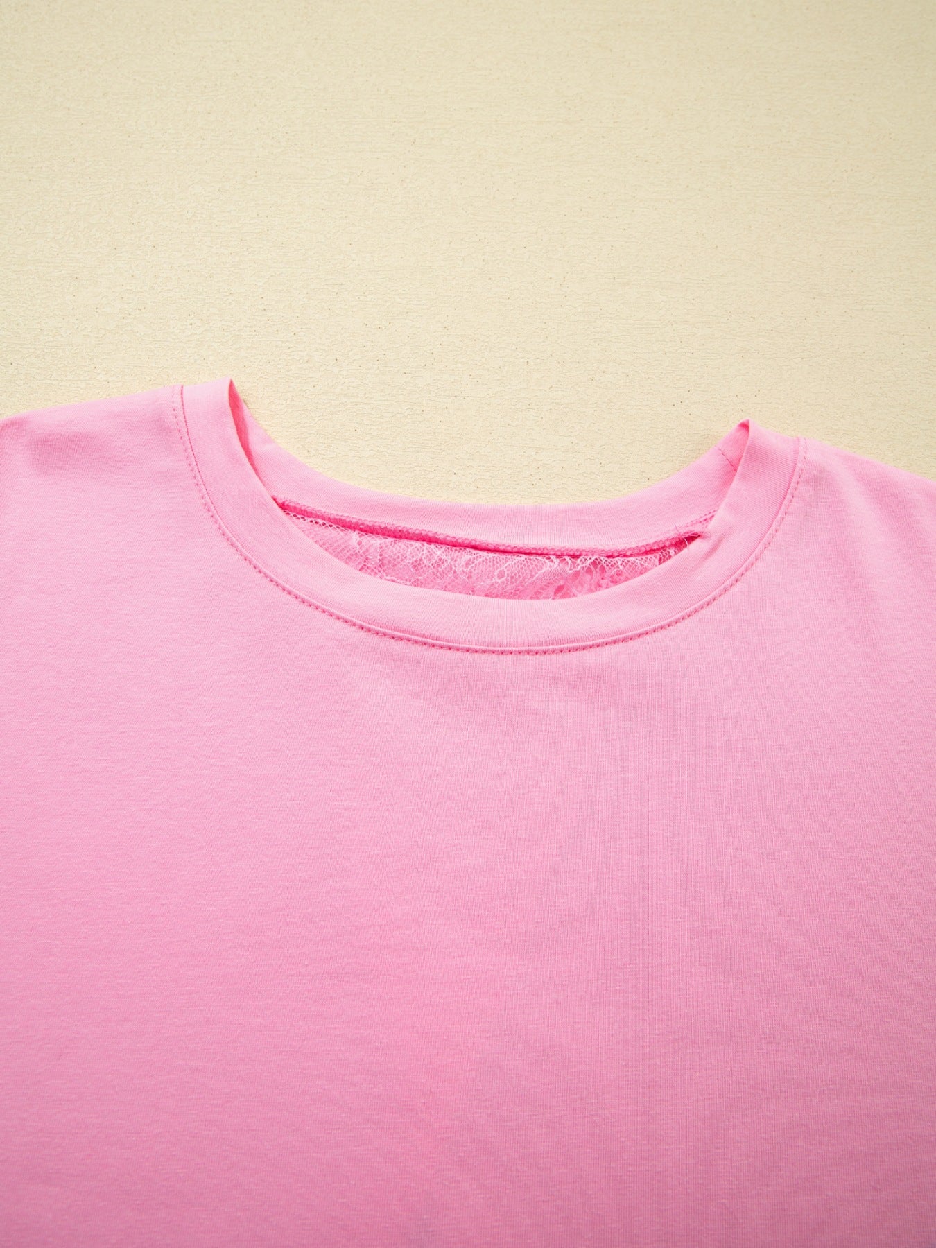 Pink cotton blend oversized tee with floral lace detail at the neckline.