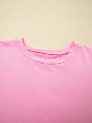 Pink cotton blend oversized tee with floral lace detail at the neckline.