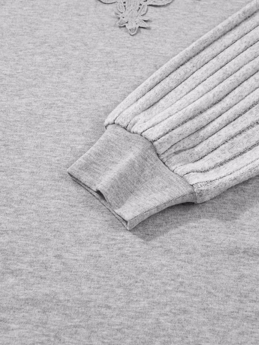 Gray ribbed knit long-sleeve top with lace detail at neckline and textured sleeves.