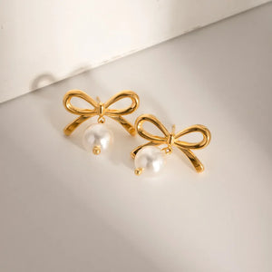 Gold bow drop earrings with pearl accents