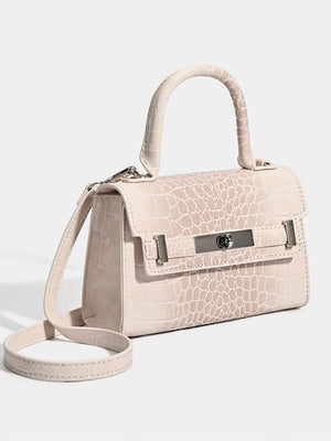 Off-white croc-embossed small tote bag with silver hardware and adjustable strap.