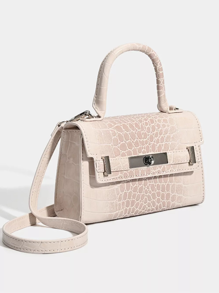 Off-white croc-embossed small tote bag with silver hardware and adjustable strap.