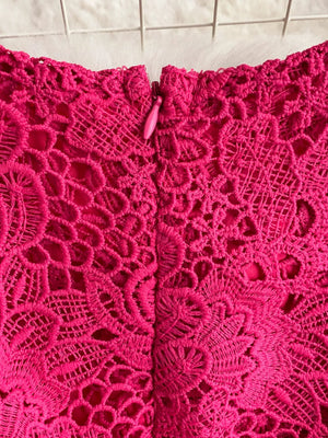Fuchsia pink lace dress with intricate floral pattern and zipper detail.