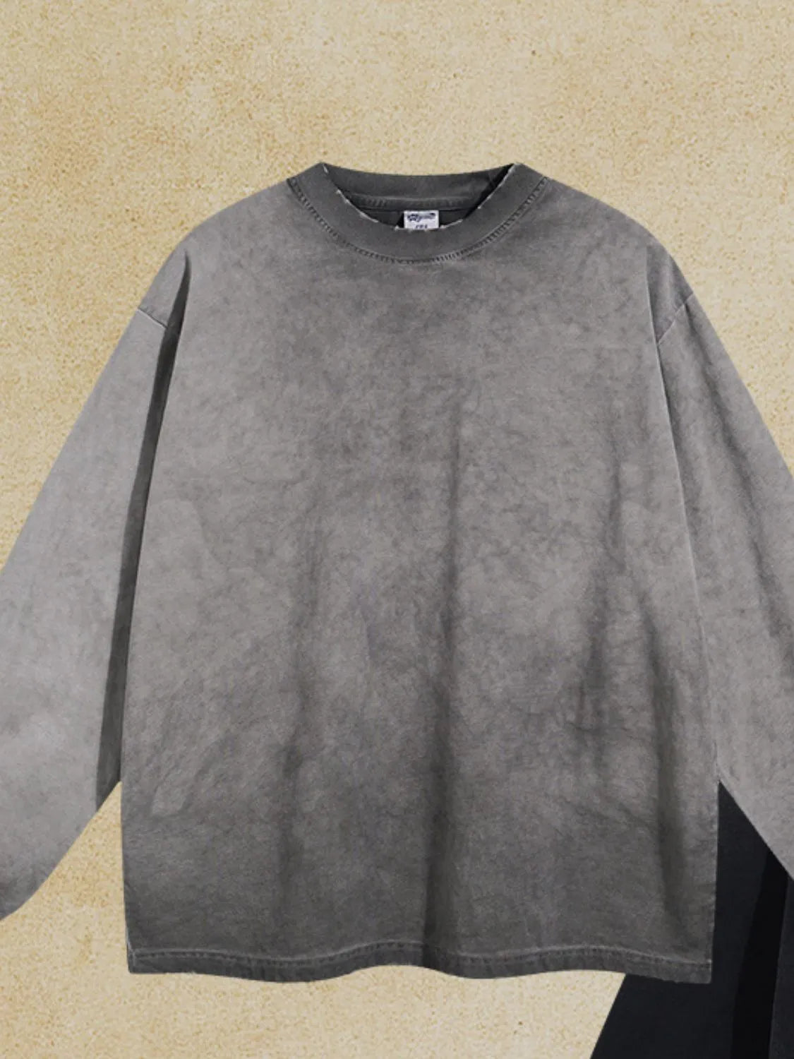 Vintage wash oversized crewneck sweatshirt in gray with a faded, mottled pattern and relaxed fit.