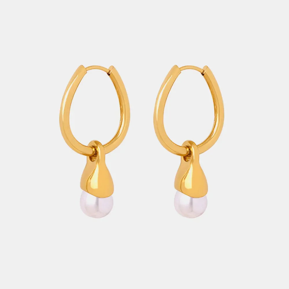 Gold oval hoop earrings with a pearl drop detail.