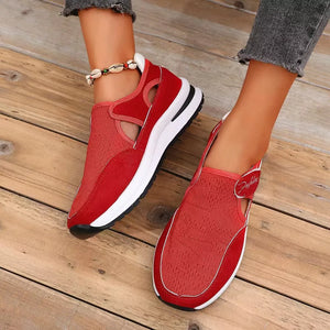 Red breathable cutout slip-on sneakers with white soles and a casual design.