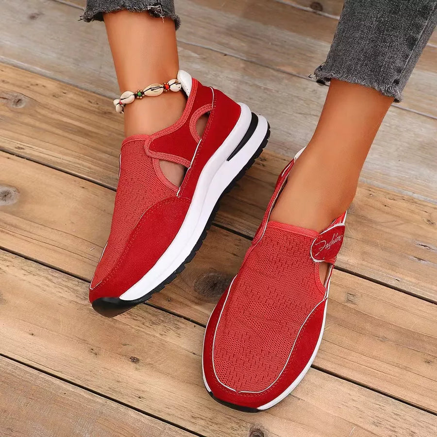 Red breathable cutout slip-on sneakers with white soles and a casual design.