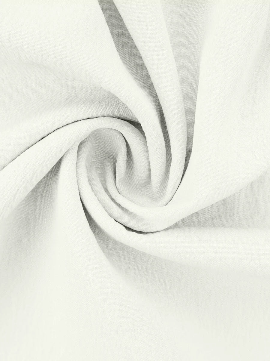 White polyester pajama fabric with soft ruffles and a textured weave.
