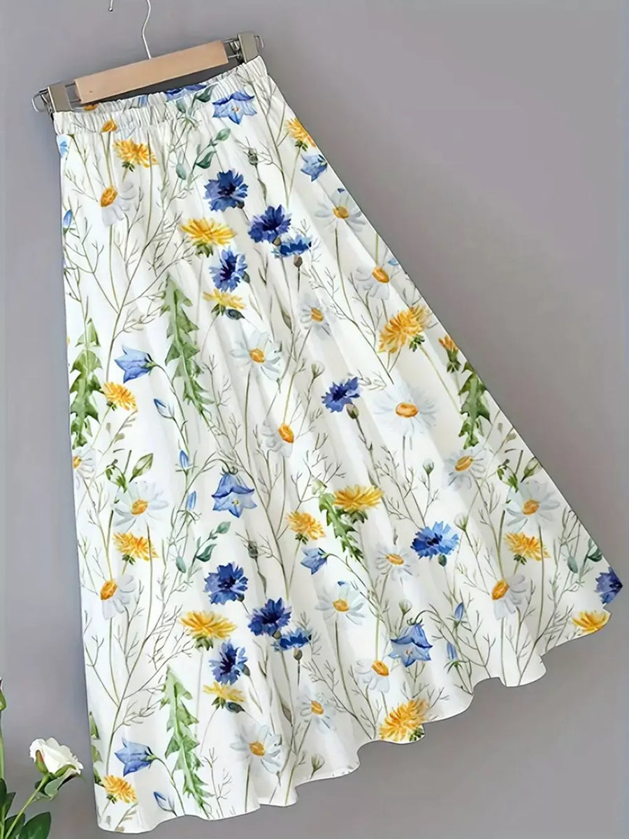 White A-line skirt with elastic waist and blue, yellow, and white floral print