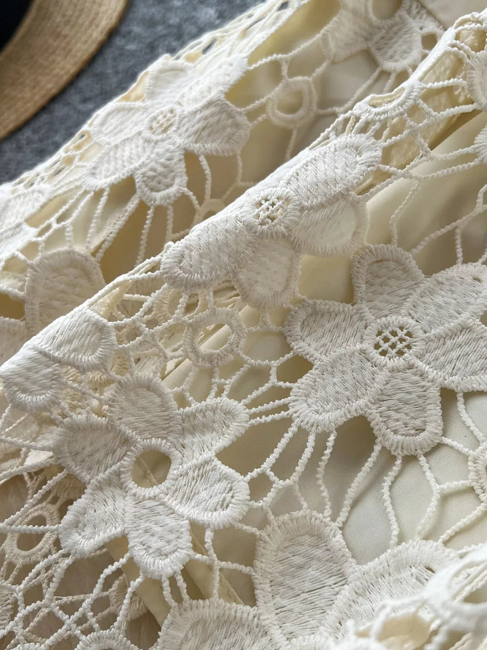 Apricot tiered lace skirt with floral detail and elastic waist.