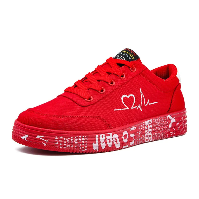 Red canvas sneakers with white heartbeat graphic and graffiti-style print on the sole.