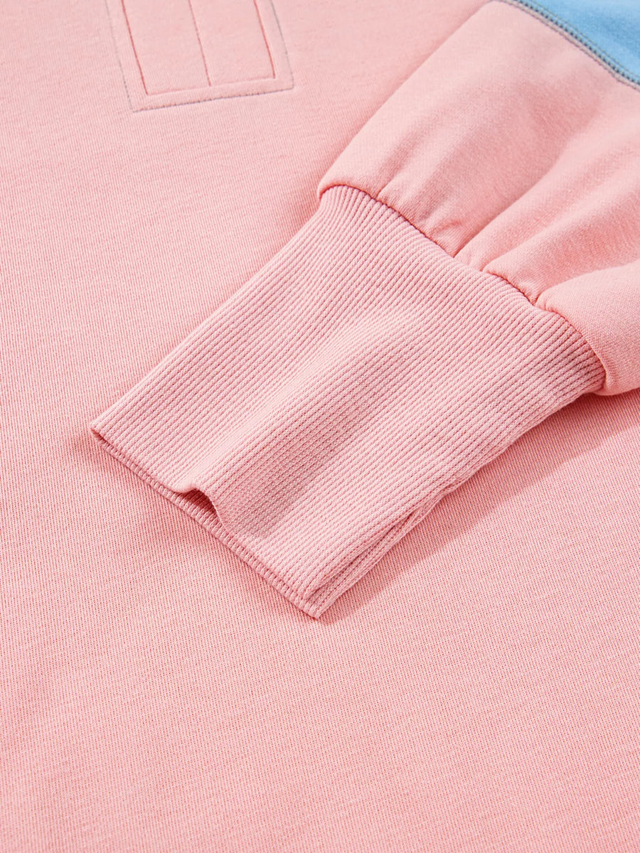 Oversized sweatshirt in dusty pink with contrast stitching detail and ribbed cuffs.
