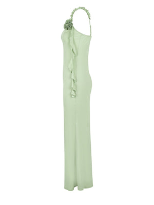 Ruffled mermaid maxi dress in light green with a single shoulder strap and floral detail.