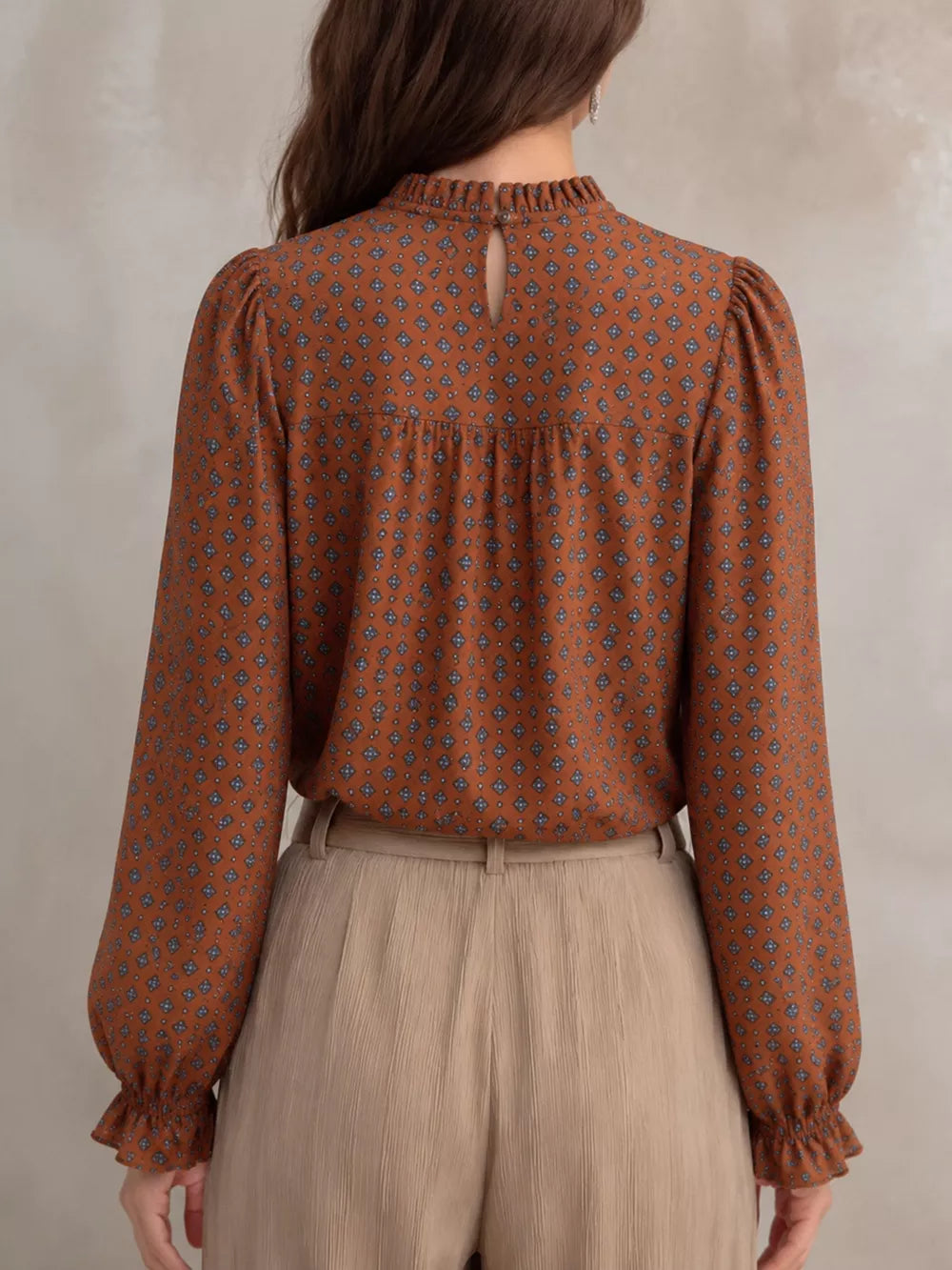 Beige blouse featuring frill and geometric