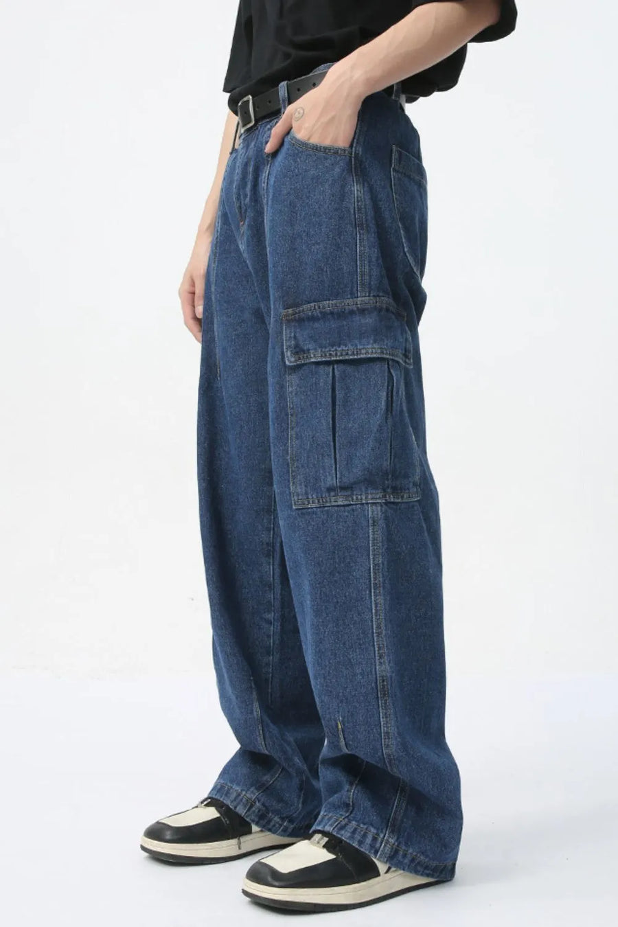 Wide-leg denim cargo pants in medium wash with pleated cargo pockets.