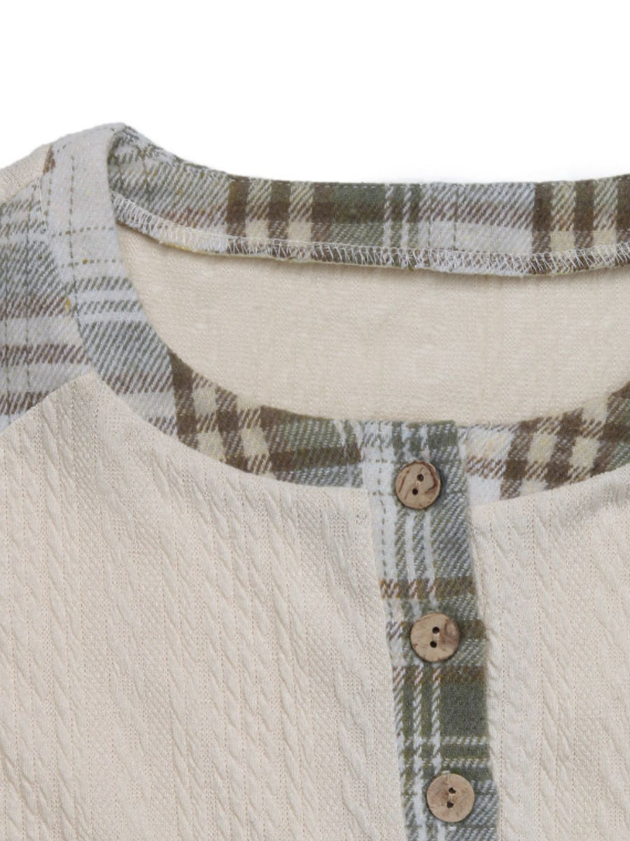 Textured cream raglan henley top with green plaid trim and wood buttons.