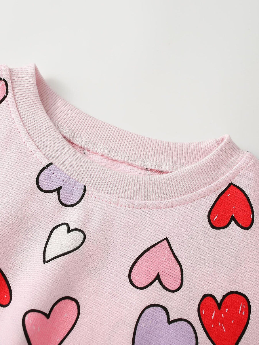 red sweatshirt featuring ribbed cuffs and heart-print