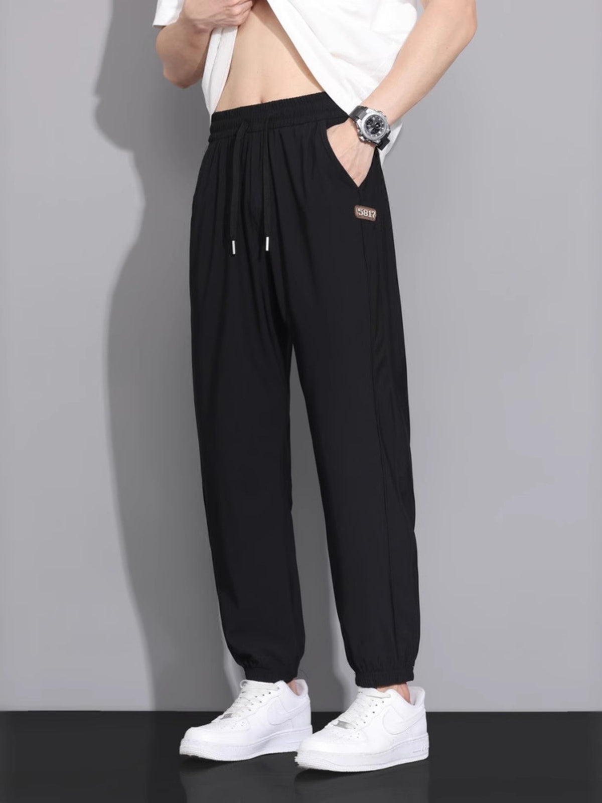 joggers in black featuring drawstring and loose fit