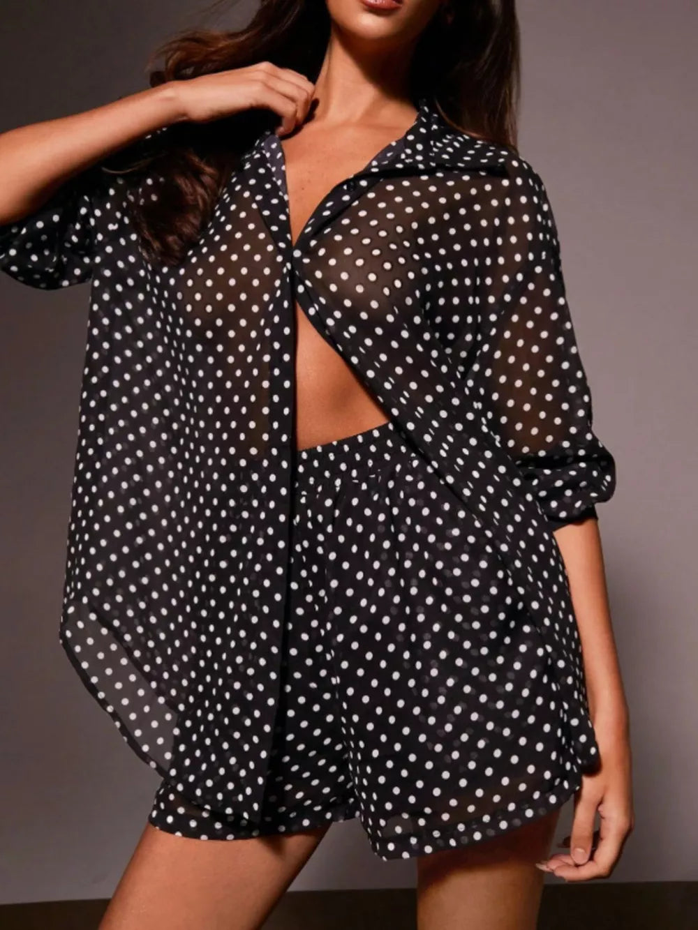 Sheer polka dot two-piece set in black with button-down shirt and shorts.