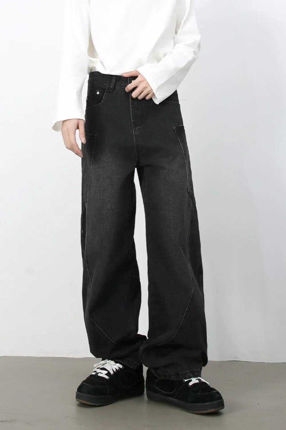 Black denim baggy trousers with a relaxed fit and visible stitching detail.