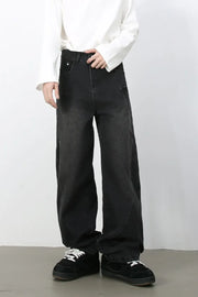 Black denim baggy trousers with a relaxed fit and visible stitching detail.