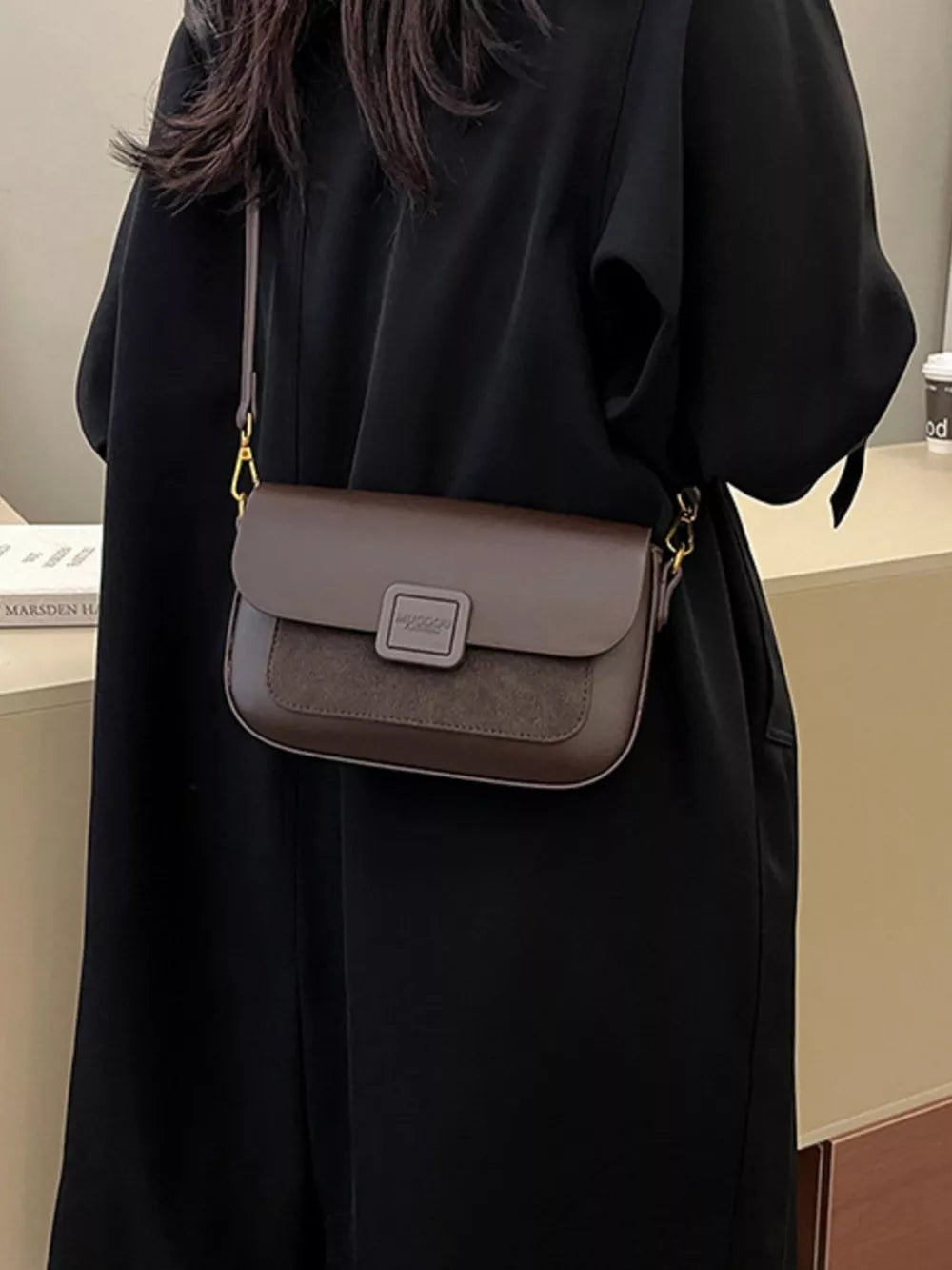Chic two-tone crossbody bag in coffee brown with suede flap and gold hardware.